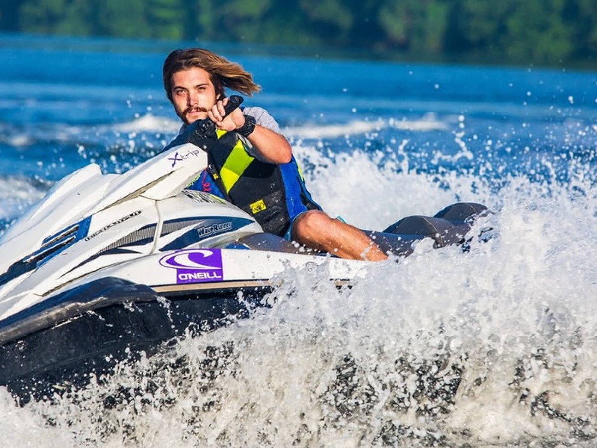 a man riding a wave on a surf board on a body of water